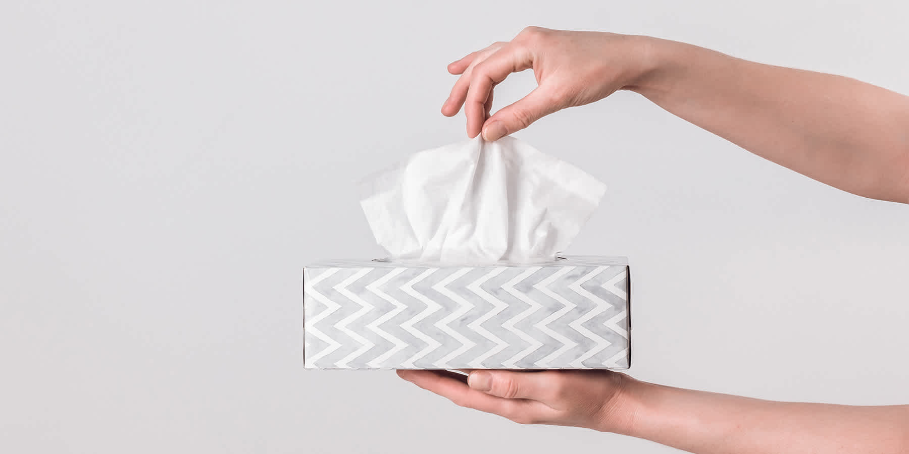 Person holding a box of tissues