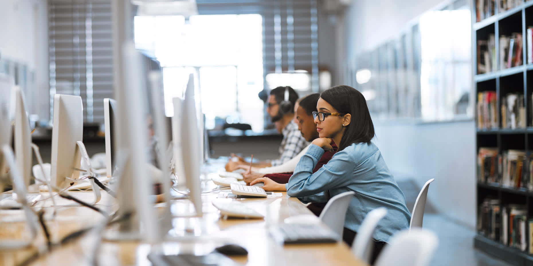 Young woman on desktop computer looking up if ovarian cysts are genetic