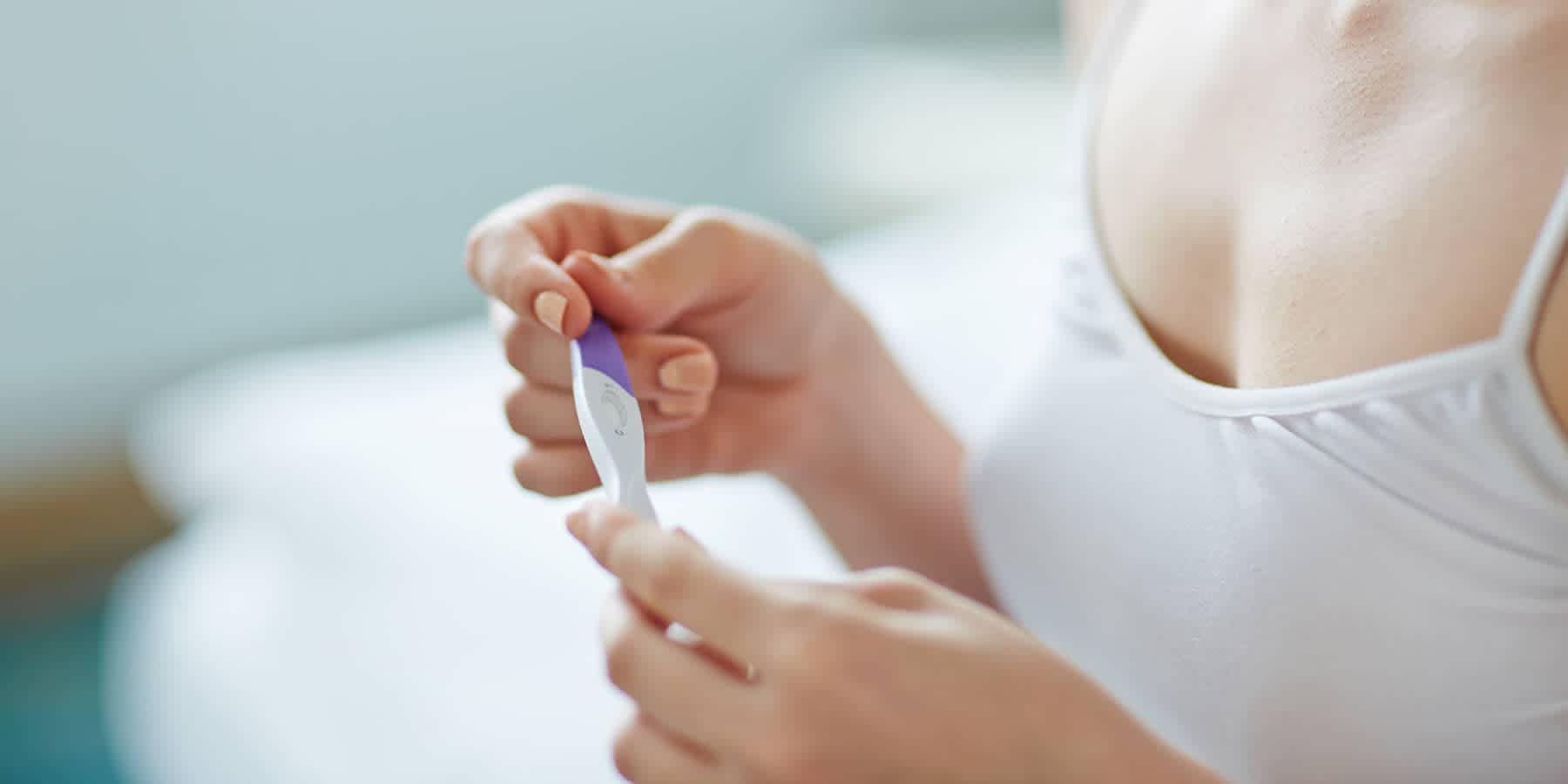 Woman with one ovary looking at pregnancy test results