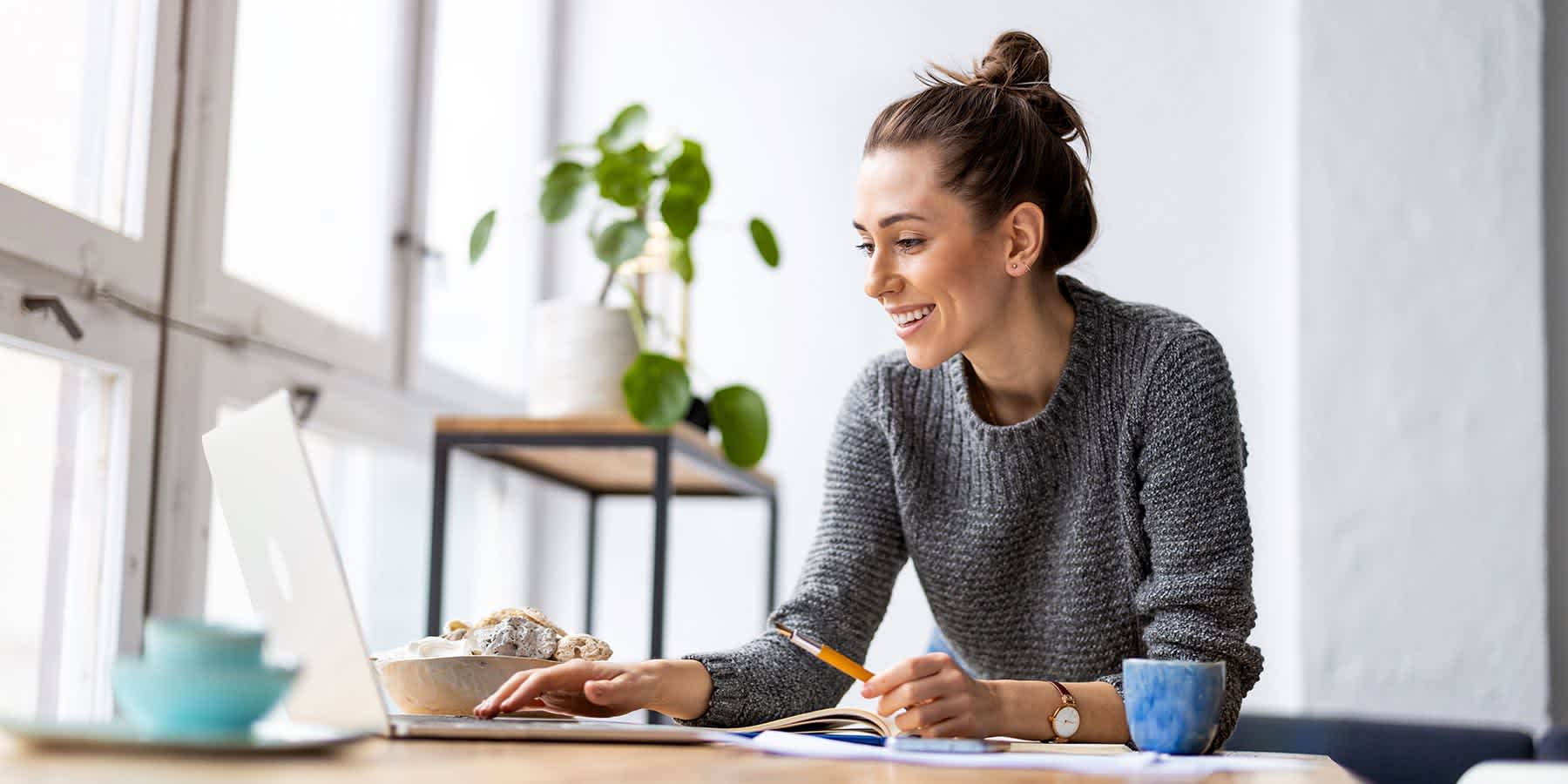 Woman researching celiac diet plan on laptop