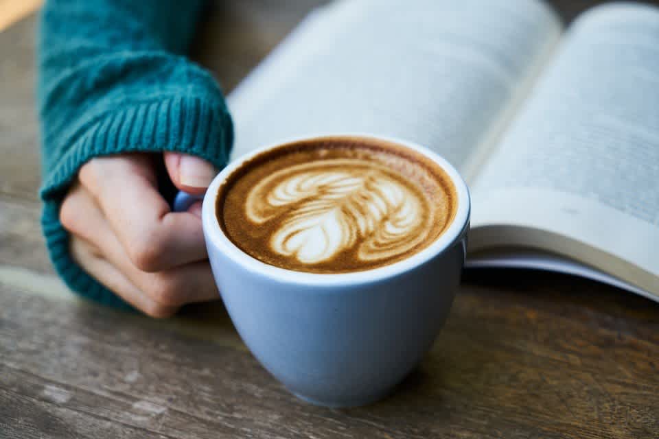 Person about to take a sip of coffee while wondering if caffeine makes you gain weight