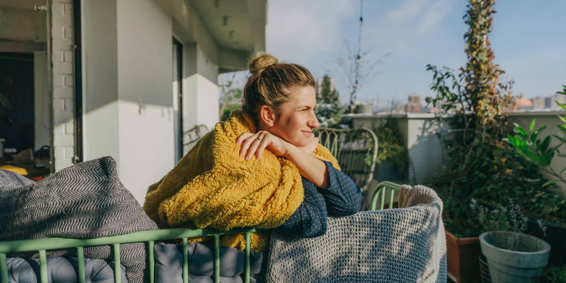 Woman leaning on a railing in the sun