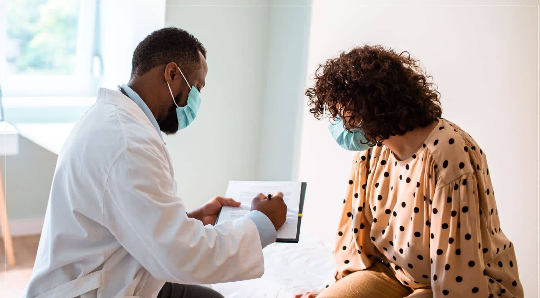 Healthcare provider explaining to woman how hepatitis C is treated