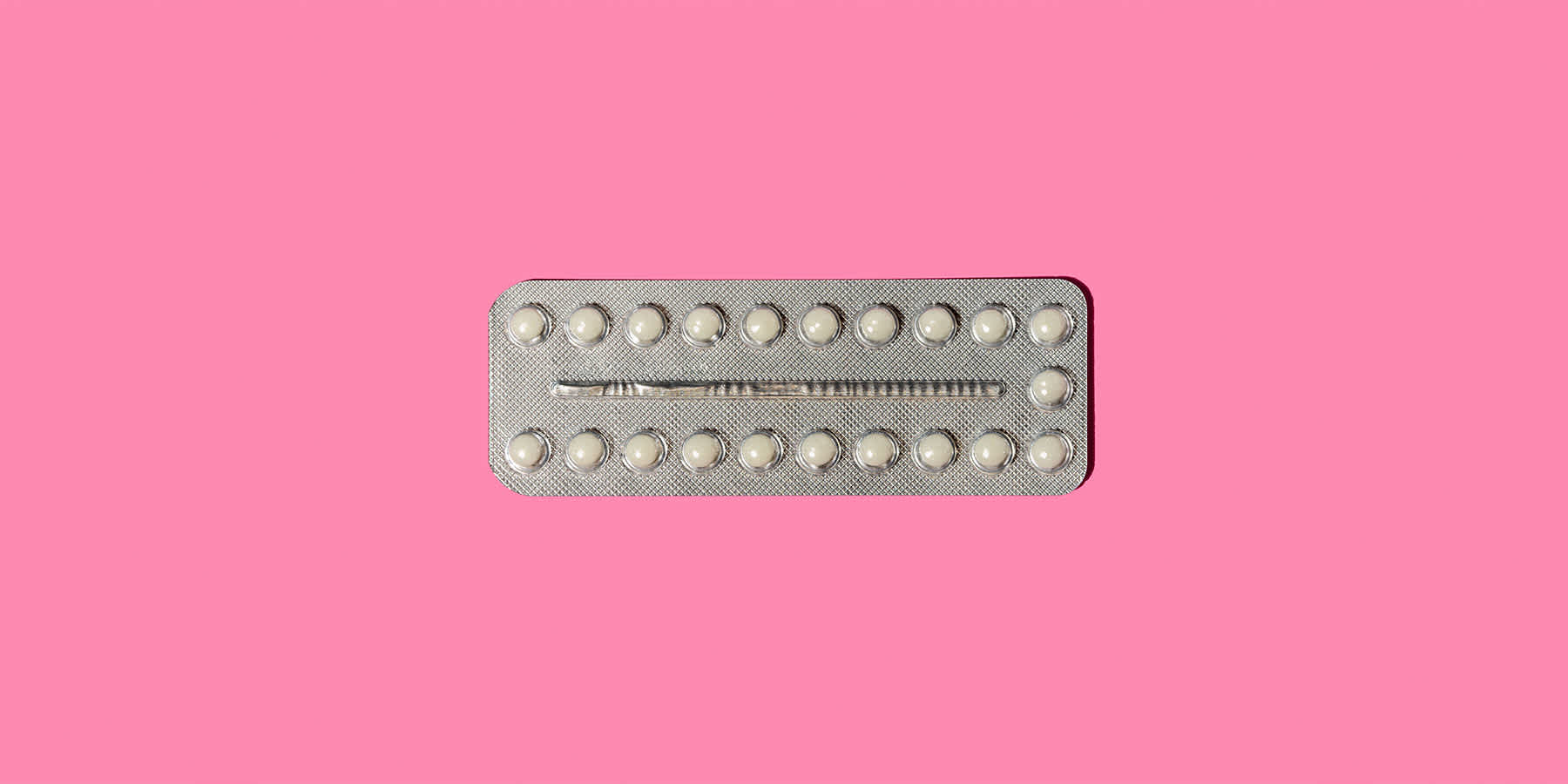 Estrogen oral medication against pink background