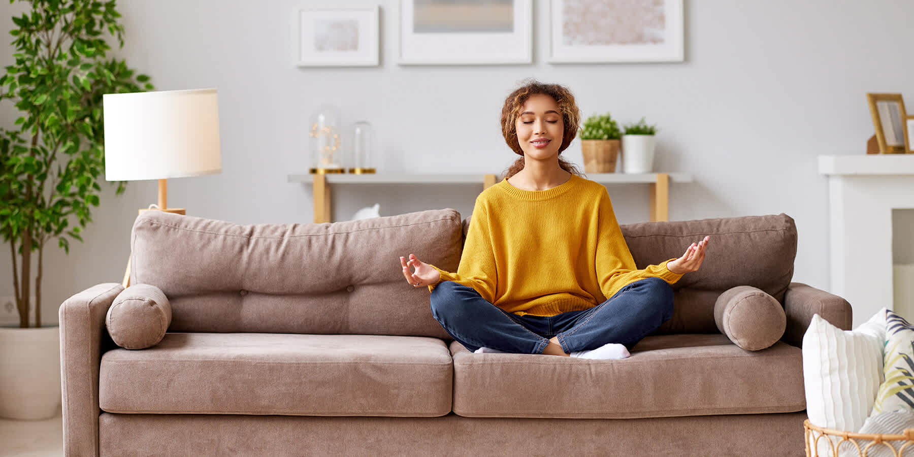 Woman in bed striking meditation pose