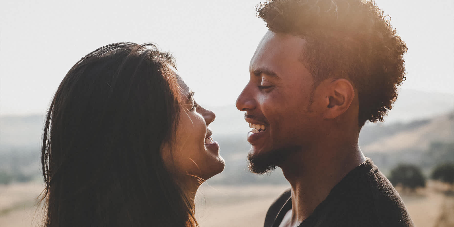 Couple looking and smiling at each other after successfully dating and living with herpes