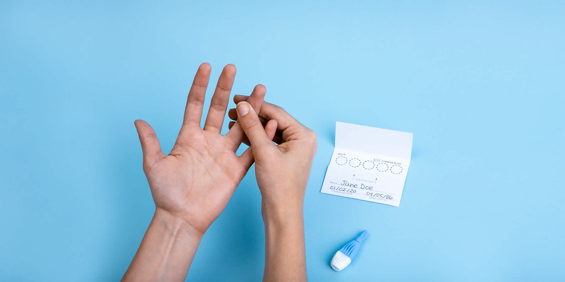 Person with prediabetes collecting finger prick blood sample for HbA1c blood sugar monitoring