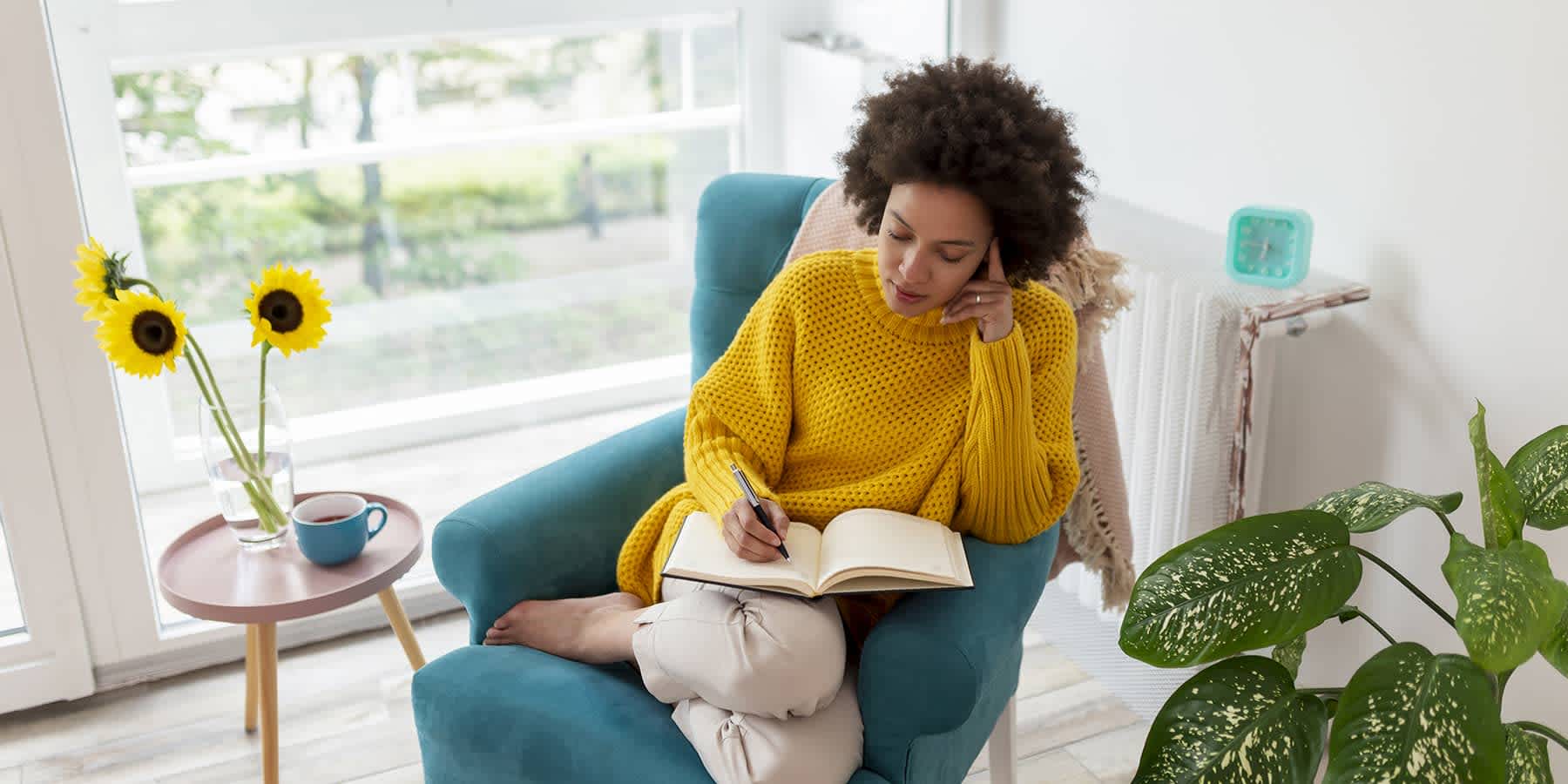 Young woman sitting on chair and researching the signs of colon cancer in women