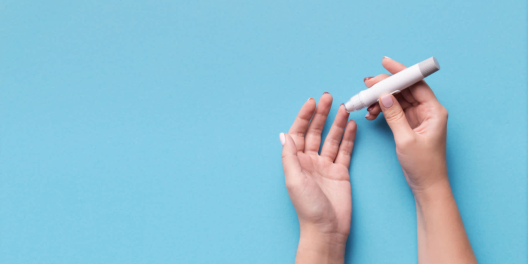 Person with diabetes collecting blood sample with fingerstick for glucose monitoring after taking GLP-1 drugs