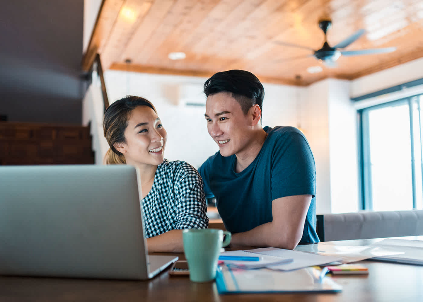 Couple using laptop to look up what is a flexible savings account