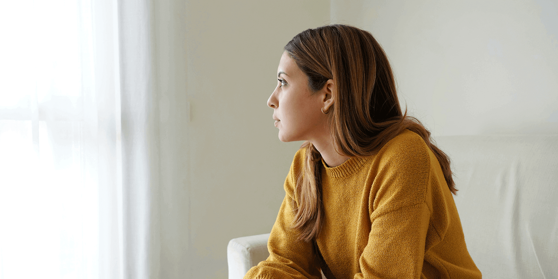 Picture of a woman looking out a window