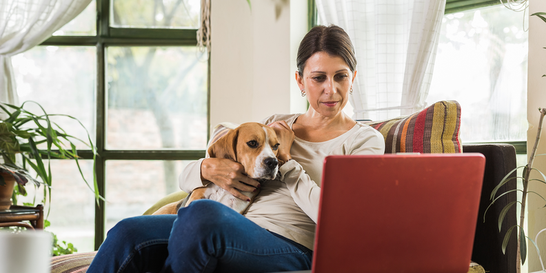 Woman with laptop looking up if a UTI can go away on its own