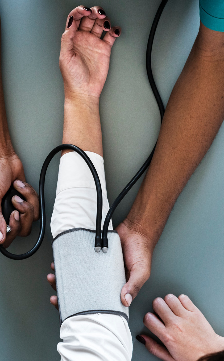 Provider checking someone's blood pressure and Hba1c levels