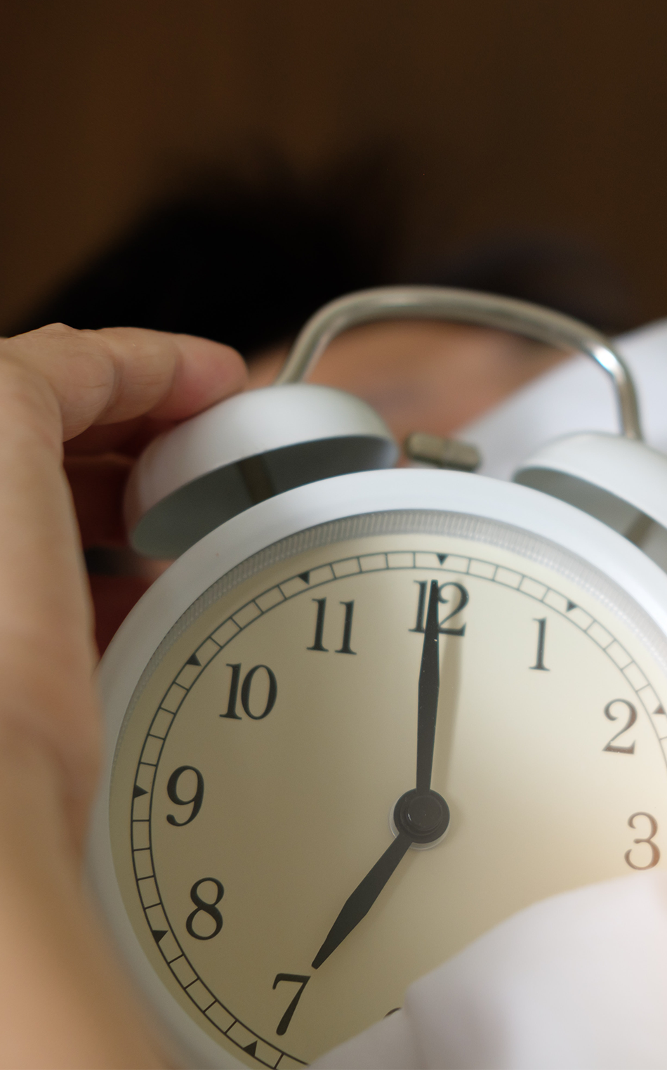 Person holding clock worrying about stress and sleep health