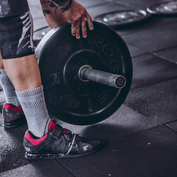 Man lifting weights and thinking about testosterone